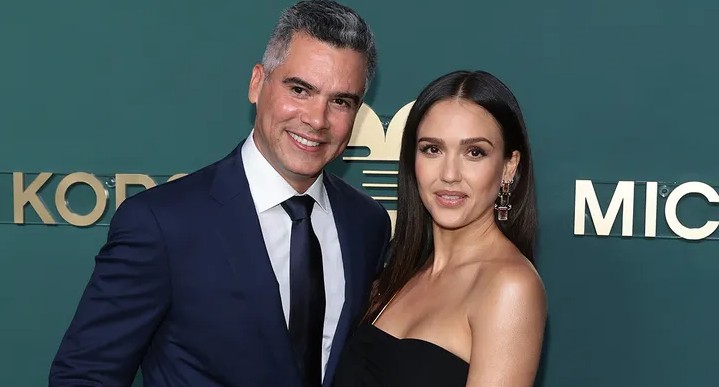 Jessica Alba in a green bikini sipping from a coconut during her Mexico vacation